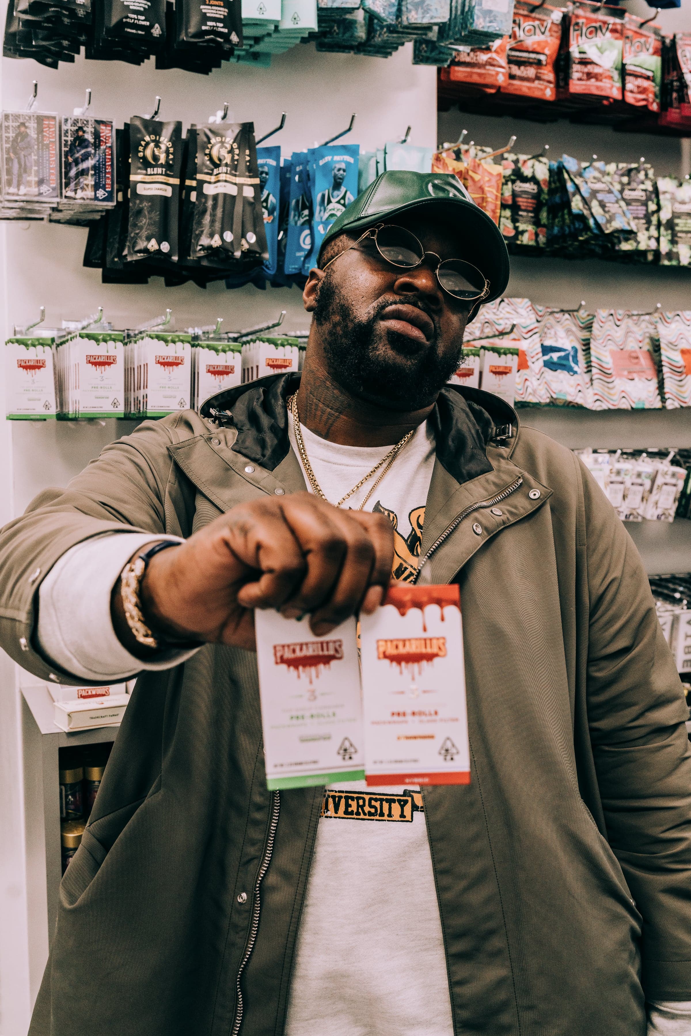 A man in sunglasses poses with cannabis products